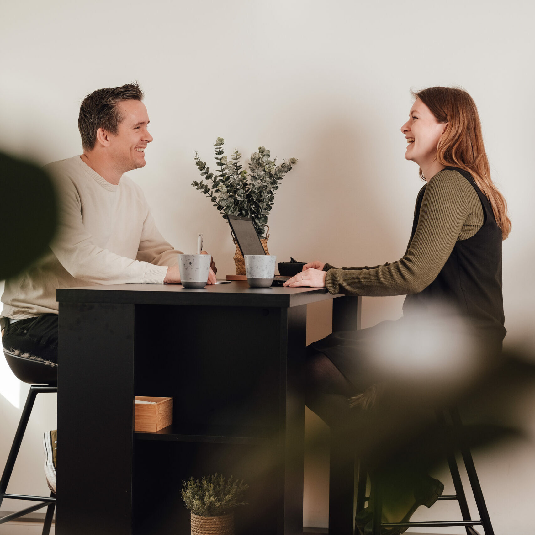 Two colleagues talking over a cup of coffee at the office